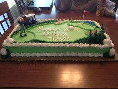 a birthday cake with a golf theme on the top is sitting on a wooden table