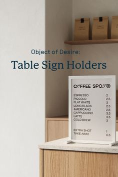 the table sign holders are on top of a counter