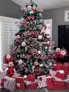 a christmas tree decorated with minnie mouses and candy canes