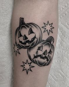 a couple of pumpkins with faces on each side of their legs and stars around them