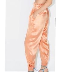 Nwt Size L. I Bought Two Pairs From Zara Online Store, Keeping One Pair Selling The Other. I Get Tons Of Compliments When I Wear These Pants. Zara Tangerine Orange Satin Finish High Waist Trousers Pants, High Waist, Buttons Hem, Side Pockets, Back Faux Pockets 100% Viscose Approx Measurement Length 41" Inseam 27" Waist Has Zipper Closure But Waistband Also Stretches Smoke Free And Pet Free Home. Bundle Any 3 Items From My Poshmark Closet For At Least 15% Discount Orange Fitted Bottoms With Elastic Waistband, Fitted Orange Bottoms With Elastic Waistband, High-waist Peach Bottoms For Spring, High Waist Peach Bottoms For Spring, Orange Pants For Summer Loungewear, Orange Bottoms For Summer Loungewear, Orange Summer Loungewear Pants, Casual High Waist Peach Bottoms, Summer Tapered Leg Pants For Party