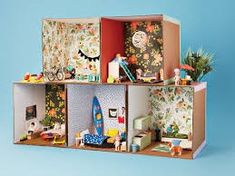 a doll house with furniture and accessories in it's display case on a blue background