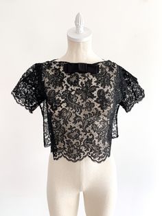 a mannequin wearing a black lace top