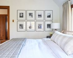 a bedroom with pictures on the wall above the bed