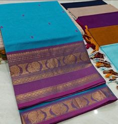 This saree comes with beautiful kanchivaram style gold/copper zari woven borders on chettinad cotton with body woven buttas. Pallu has simple and elegant stripes with buttas. These sarees are a fusion of Chettinad Cottons sarees with Kanchivaram style copper/gold zari woven borders. Running Blouse (5.5 + 0.7 m) Fall and pico - not done Blue Cotton Dupatta With Zari Weaving, Blue Cotton Saree With Printed Border, Blue Cotton Traditional Wear With Printed Border, Blue Cotton Saree For Navratri, Blue Cotton Saree For Diwali, Blue Cotton Saree With Zari Weaving, Purple Cotton Traditional Wear With Cutdana, Purple Cotton Traditional Wear With Zari Work, Purple Handloom Cotton Traditional Wear