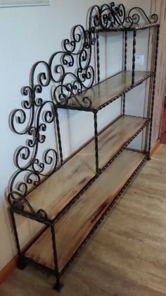 a metal shelf with two wooden shelves on each side and an iron frame above it