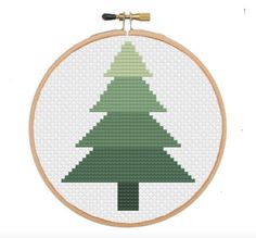 a cross stitch christmas tree on a white background