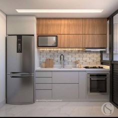 a kitchen with stainless steel appliances and white counter tops, along with wooden cabinets on both sides