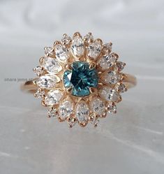 Blue Moissanite Art Deco Ring, Cyan Blue Moissanite Engagement Ring, Wedding Ring, Anniversary Gift Engagement Ring, Wedding Gift Ring → center stone type : Moissanite → center stone shape : Round → center stone color : Blue → center stone size : 5 → center stone clarity : vvs → luster : exellent → make : High Quality → Moissanite MOHs scale : 9.25 → Moissanite refractive index : 2.65 SIDE STONE DETAIL → side stone shape : Marquise & Round ( Lab Diamond ) → side stone color : G (white) → sid Blue Moissanite Engagement Ring, Earrings Outfit, Blue Moissanite, Blue Diamond Ring, Oval Diamond Ring, Mohs Scale, Cyan Blue, Gold Bracelets, Rose Engagement Ring