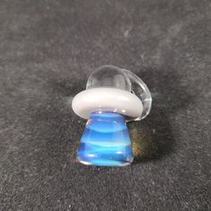 a blue and white object sitting on top of a carpet