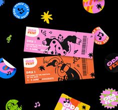 two tickets are laying next to each other on a black background with colorful stickers