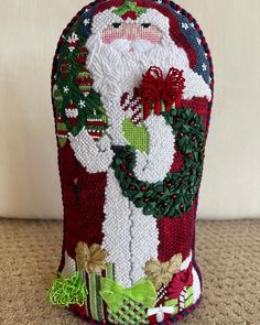 a santa clause christmas stocking holder on the floor