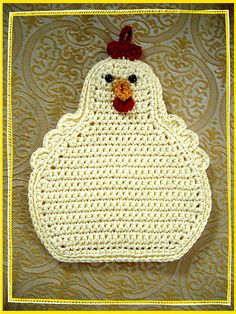 a crocheted chicken with a red bow on it's head is shown