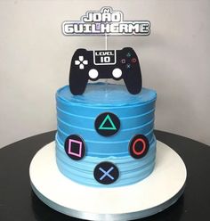 a birthday cake made to look like a video game controller on top of stacks of stacked discs