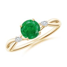 an oval emerald and diamond ring in yellow gold