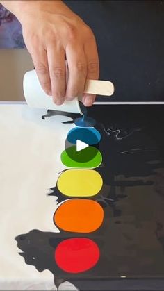 a person is using a paint roller to color circles