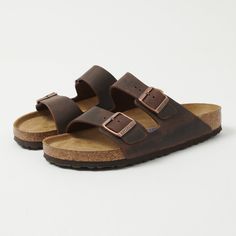 The Arizona from Birkenstock has rightly earned its place as a classic of comfort footwear. With a simple two strap design, an orthopaedic super-soft footbed, and EVA soul, this sandal is a great option for the summer months. The upper of this design is made from a thick oiled leather, while every single pair is still hand-made in Germany. Regular fit Thick oiled leather upper Two strap design Orthopaedic designed footbed EVA soul Twin metal pin buckles Product code: 0452761 Made in Germany Classic Brown Slip-on Footbed Sandals, Comfortable Double Strap Leather Footbed Sandals, Classic Open Toe Slippers With Cushioned Footbed, Comfortable Footbed Sandals With Single Toe Strap, Classic Sandals With Leather Footbed And Round Toe, Comfortable Leather Footbed Closed Toe Sandals, Comfortable Brown Double Strap Slides, Classic Open Toe Slippers With Leather Footbed, Classic Footbed Sandals With Cork-bed Midsoles And Round Toe