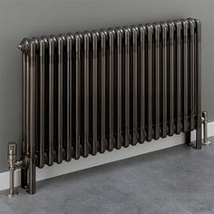 a large metal radiator in the corner of a room next to a wall