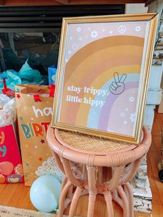 there is a picture frame on top of a small stool in front of some presents