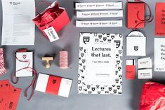 an assortment of red and white stationery items laid out on top of each other