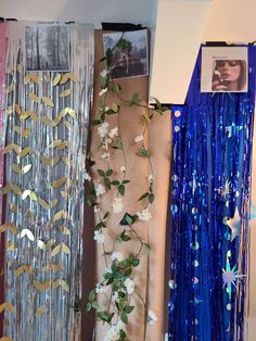 there are many different types of streamers hanging on the wall with flowers and leaves