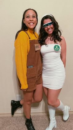 two women dressed in costumes posing for the camera