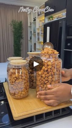 two jars filled with food sitting on top of a counter