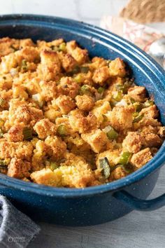 a blue casserole dish filled with stuffing