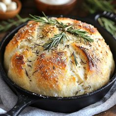 a close up of a bread in a skillet on a table with other food items