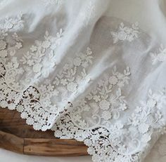 white lace is on top of a piece of cloth