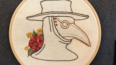 the embroidery pattern shows a bird wearing a hat