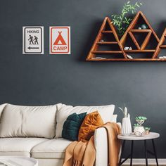 a living room filled with furniture and pictures on the wall next to a coffee table