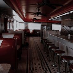 the interior of a diner with stools and tables