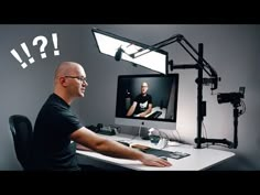 a man sitting at a desk in front of a computer