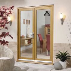 an image of a patio with sliding glass doors and potted plant in the corner