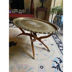 a table sitting on top of a rug in a living room