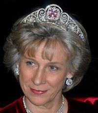 an older woman wearing a tiara and smiling at the camera