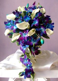 a vase filled with blue and white flowers