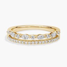 a yellow gold ring with three rows of diamonds on the side and one row of white stones