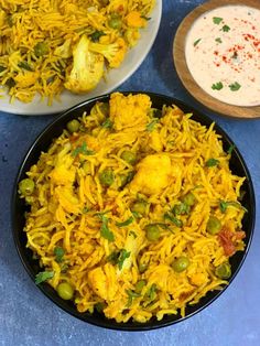 a bowl filled with yellow rice and vegetables