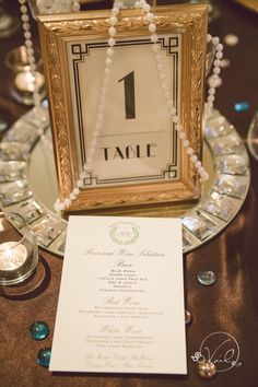 an image of a table setting for a wedding with place cards and beads on it