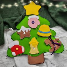 a felt christmas tree with various items on it