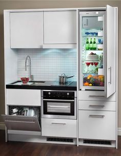 an open refrigerator in the middle of a kitchen