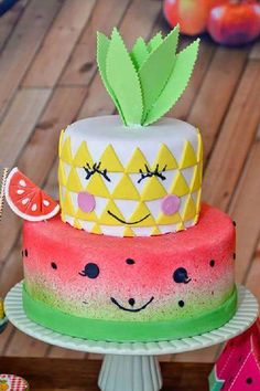 a watermelon and pineapple cake on a table