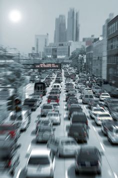 a blurry photo of traffic on a busy city street in the middle of winter