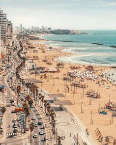 the beach is crowded with people and cars