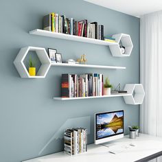 a computer on a desk with shelves above it