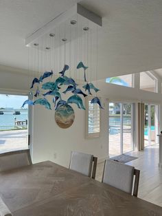 a chandelier hanging from the ceiling in a dining room with dolphins on it