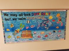 a bulletin board on the wall in a school room with an image of a dolphin and other marine life