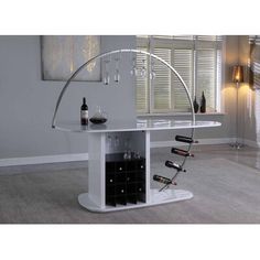 a white table with wine bottles and glasses on it